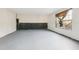Spacious unfinished basement with painted floor, neutral walls, and a window providing natural light at 245 London Ln, Hiram, GA 30141