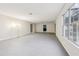 Large unfinished basement featuring concrete floors, access to the backyard, and neutral paint throughout at 245 London Ln, Hiram, GA 30141