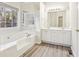 Elegant bathroom featuring a large tub, double sinks, and modern fixtures at 245 London Ln, Hiram, GA 30141