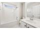 This all-white bathroom features a tub/shower combo, a new vanity and a window for natural light at 245 London Ln, Hiram, GA 30141