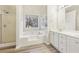 Luxurious bathroom with a soaking tub, separate shower, and dual vanity sinks at 245 London Ln, Hiram, GA 30141