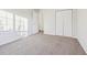 This bedroom has neutral carpet, a closet, and fresh paint throughout at 245 London Ln, Hiram, GA 30141
