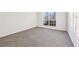 This bedroom features neutral carpet, a window providing natural light, and is freshly painted at 245 London Ln, Hiram, GA 30141