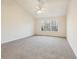Spacious bedroom featuring a ceiling fan, plush carpet, and a large window view at 245 London Ln, Hiram, GA 30141