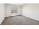 Comfortable bedroom with plush carpet, neutral tones, and a view of the outdoors at 245 London Ln, Hiram, GA 30141