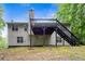 Rear exterior featuring deck and stairs to the backyard, enhancing outdoor living and accessibility at 245 London Ln, Hiram, GA 30141
