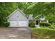 Charming home with a two-car garage, mature trees, and a well-maintained lawn at 245 London Ln, Hiram, GA 30141