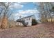 Two-story house back view with deck and stairs leading to a wooded backyard at 245 London Ln, Hiram, GA 30141