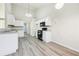 Modern kitchen with white cabinets and gray vinyl flooring at 245 London Ln, Hiram, GA 30141