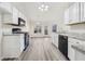 Bright kitchen with white cabinets, granite counters, and stainless steel appliances at 245 London Ln, Hiram, GA 30141