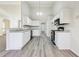 Well-lit kitchen with white cabinets, updated appliances, and granite countertops at 245 London Ln, Hiram, GA 30141