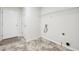 Bright laundry room with washer/dryer hookups and built-in shelving at 245 London Ln, Hiram, GA 30141