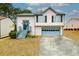 Two-story house with pink siding, blue garage door, and wooden stairs at 3251 Hunters Crossing Pt, Lithonia, GA 30038