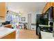 Kitchen with light wood cabinets, black appliances, and a breakfast nook at 3251 Hunters Crossing Pt, Lithonia, GA 30038