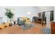 Living room with hardwood floors, comfortable seating, and a dining area at 3251 Hunters Crossing Pt, Lithonia, GA 30038