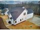 White house with gray roof, two-car garage, and backyard at 7760 Pleasant Hollow Ln, Cumming, GA 30041