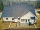 White house with gray roof, two-car garage, and backyard at 7760 Pleasant Hollow Ln, Cumming, GA 30041