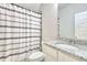 Bathroom with tub shower and granite countertop at 7760 Pleasant Hollow Ln, Cumming, GA 30041