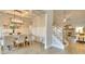 Open dining room with a large chandelier and hardwood floors at 7760 Pleasant Hollow Ln, Cumming, GA 30041