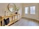 Bright entryway with a console table and large mirror at 7760 Pleasant Hollow Ln, Cumming, GA 30041