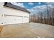 Two-car garage with white doors and concrete driveway at 7760 Pleasant Hollow Ln, Cumming, GA 30041
