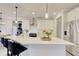 Modern kitchen with white cabinets, quartz countertops, and a large island at 7760 Pleasant Hollow Ln, Cumming, GA 30041