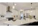 Modern kitchen with white cabinets, quartz countertops, and stainless steel appliances at 7760 Pleasant Hollow Ln, Cumming, GA 30041