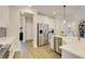 Modern kitchen with white cabinets, stainless steel appliances, and luxury finishes at 7760 Pleasant Hollow Ln, Cumming, GA 30041