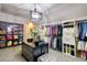 Custom walk-in closet with handbag storage and island at 7760 Pleasant Hollow Ln, Cumming, GA 30041