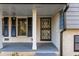 Inviting front porch with brick facade and blue shutters at 4908 Mill Brook Dr, Atlanta, GA 30338