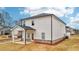 A backyard view highlights the house's covered patio and exterior finish at 701 Lily Blossom Path Path, Lawrenceville, GA 30045