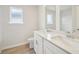 A modern bathroom has a double sink vanity with quartz countertops, a toilet, a mirror, and a window at 701 Lily Blossom Path Path, Lawrenceville, GA 30045
