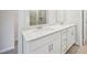 Close-up of a bathroom showcasing a double sink vanity with white cabinets and countertop at 701 Lily Blossom Path Path, Lawrenceville, GA 30045