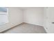 A bedroom features neutral walls, carpeted flooring, and a window at 701 Lily Blossom Path Path, Lawrenceville, GA 30045