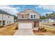 Charming two-story home featuring a stone facade and a two-car garage at 701 Lily Blossom Path Path, Lawrenceville, GA 30045