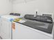 Functional laundry area with a modern washing machine and dryer, offering convenience for daily chores at 701 Lily Blossom Path Path, Lawrenceville, GA 30045