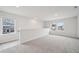 An airy loft space features soft carpet, natural light from windows, and a view of the surrounding neighborhood at 701 Lily Blossom Path Path, Lawrenceville, GA 30045