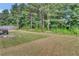 Large backyard with grassy areas and tree line at 1354 Slate Bend Dr, Dacula, GA 30019