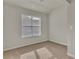 Well-lit bedroom featuring neutral walls and carpet flooring at 1354 Slate Bend Dr, Dacula, GA 30019