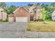 Brick two-story home with a two-car garage and manicured lawn at 1354 Slate Bend Dr, Dacula, GA 30019