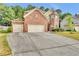 Brick two-story home with a two-car garage and manicured lawn at 1354 Slate Bend Dr, Dacula, GA 30019
