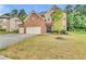 Brick two-story home with a two-car garage and manicured lawn at 1354 Slate Bend Dr, Dacula, GA 30019