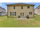 Two-story house back with patio, grill, and grassy yard at 1354 Slate Bend Dr, Dacula, GA 30019