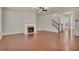 Living room with hardwood floors, fireplace, and staircase at 1354 Slate Bend Dr, Dacula, GA 30019