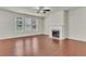 Living room with hardwood floors, fireplace, and large windows at 1354 Slate Bend Dr, Dacula, GA 30019