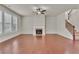 Spacious living room featuring hardwood floors, a fireplace, and large windows at 1354 Slate Bend Dr, Dacula, GA 30019