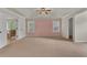 Large main bedroom with high ceilings and pink accent wall at 1354 Slate Bend Dr, Dacula, GA 30019