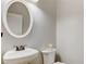 Small powder room with white sink and oval mirror at 1695 Mosaic Way, Smyrna, GA 30080