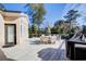 Backyard deck featuring an outdoor dining set, a grill, and a view of the surrounding landscape at 171 Johnson Ferry Nw Rd, Atlanta, GA 30328