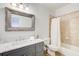 Bathroom with marble countertop, gray vanity, and tub shower at 171 Johnson Ferry Nw Rd, Atlanta, GA 30328